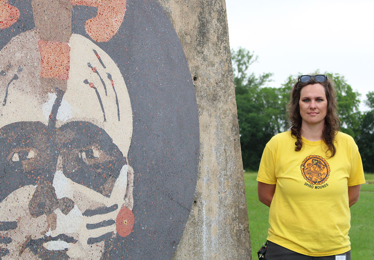 91免费福利网 graduate Anna Vincent stands next to the entrance sign at the Spiro Mounds Archaeological Center