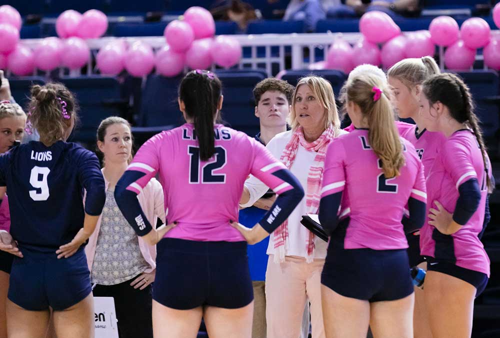 Head coach Jane Sargent talks with her team during the 2021 Pink Out